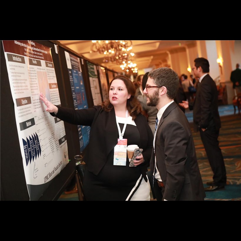 A poster presenter discusses her work with an attendee. Ninety posters were featured at this year&#39;s conference.